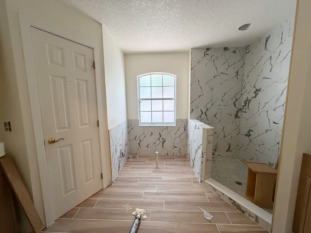 Tiled shower and floor before final fixtures in the Calle bathroom.