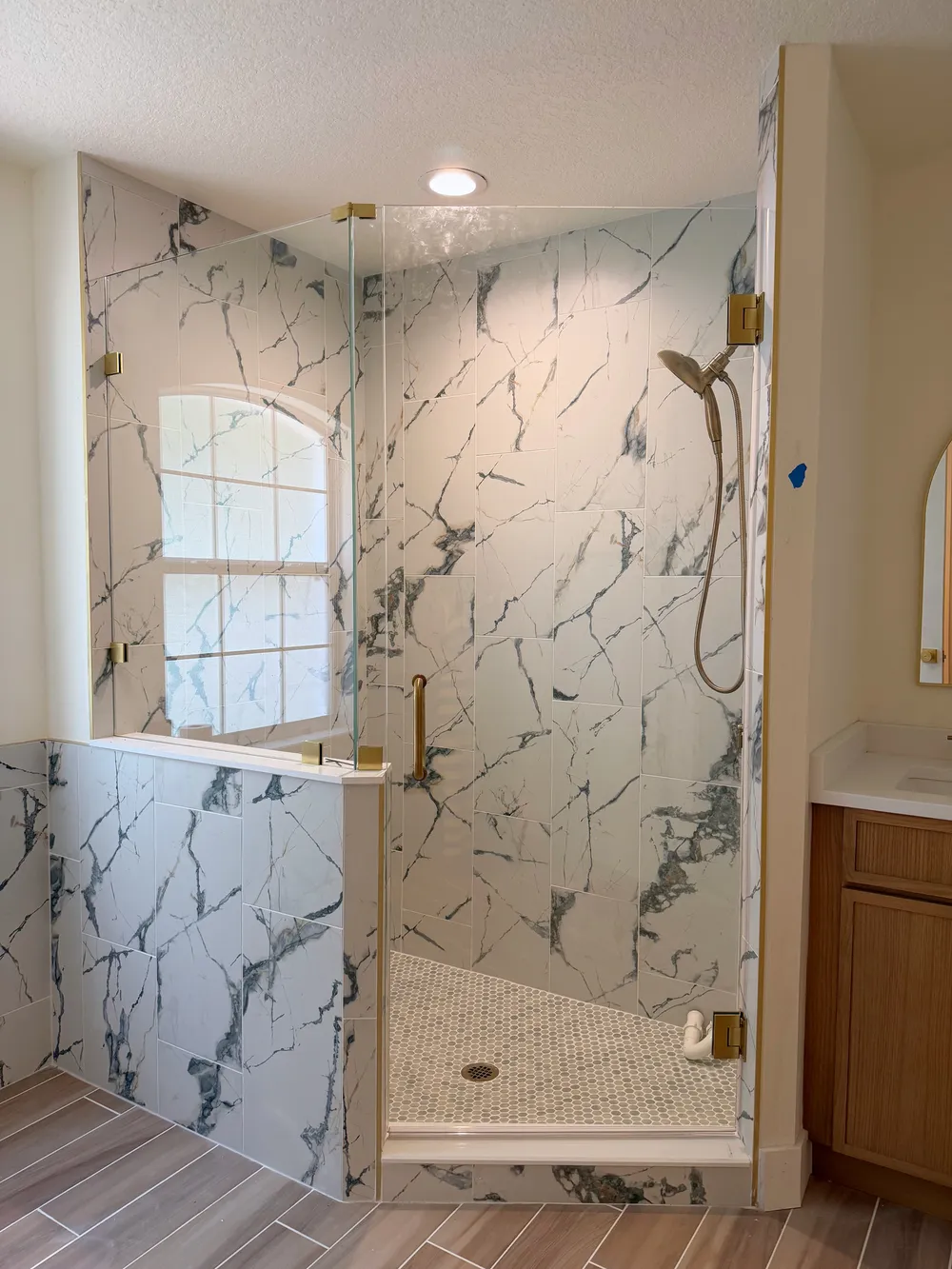 Glass shower enclosure during finish work in the Calle bathroom.