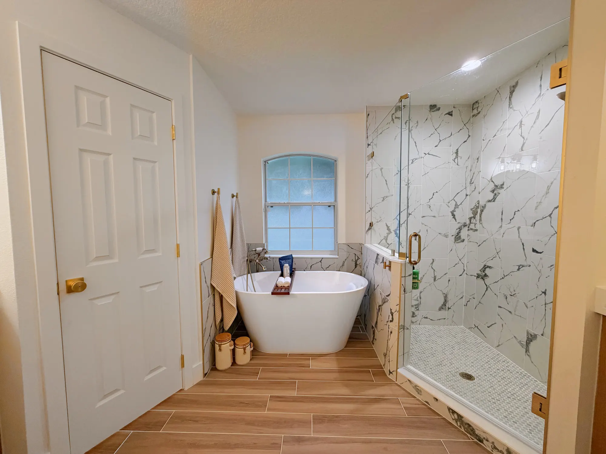 The finished bathroom, with a freestanding tub and glass shower in the Calle bathroom.