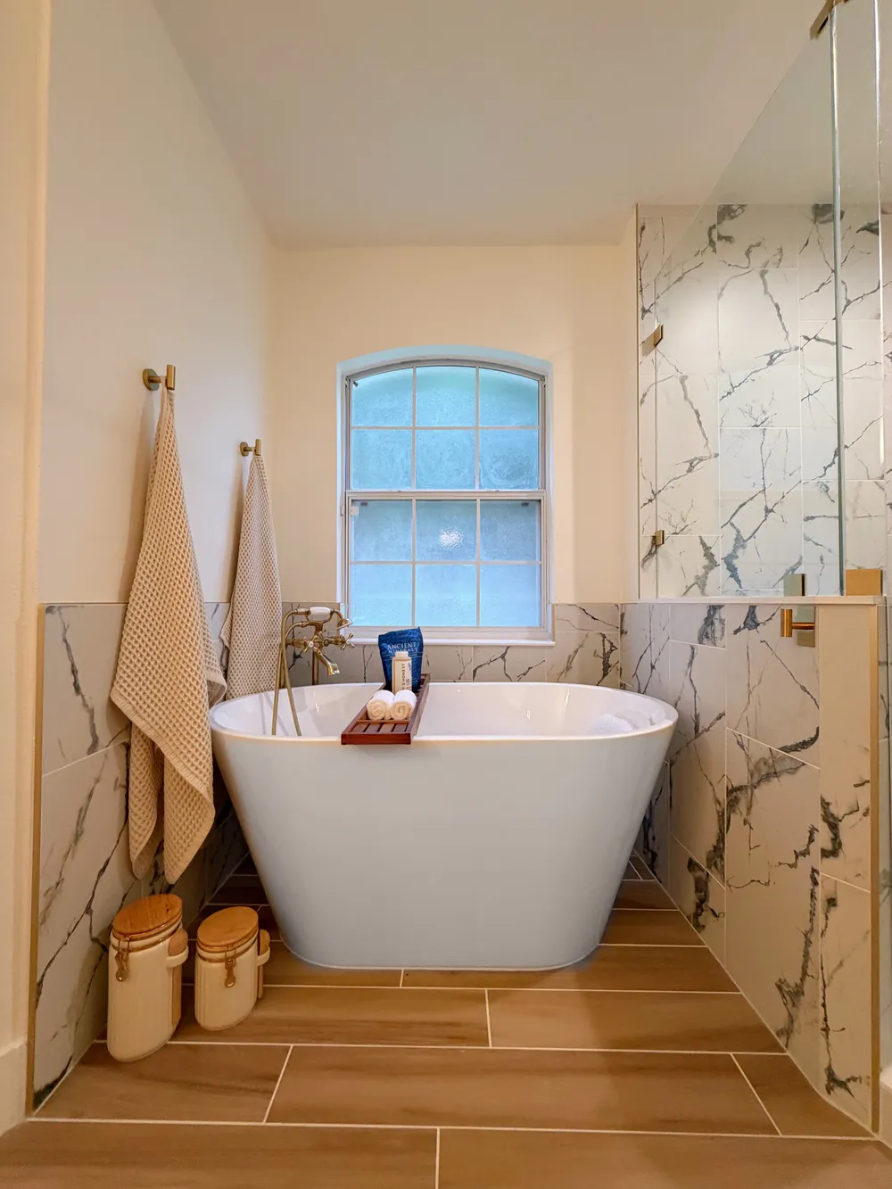 Tub beneath the arched window in the Calle bathroom.