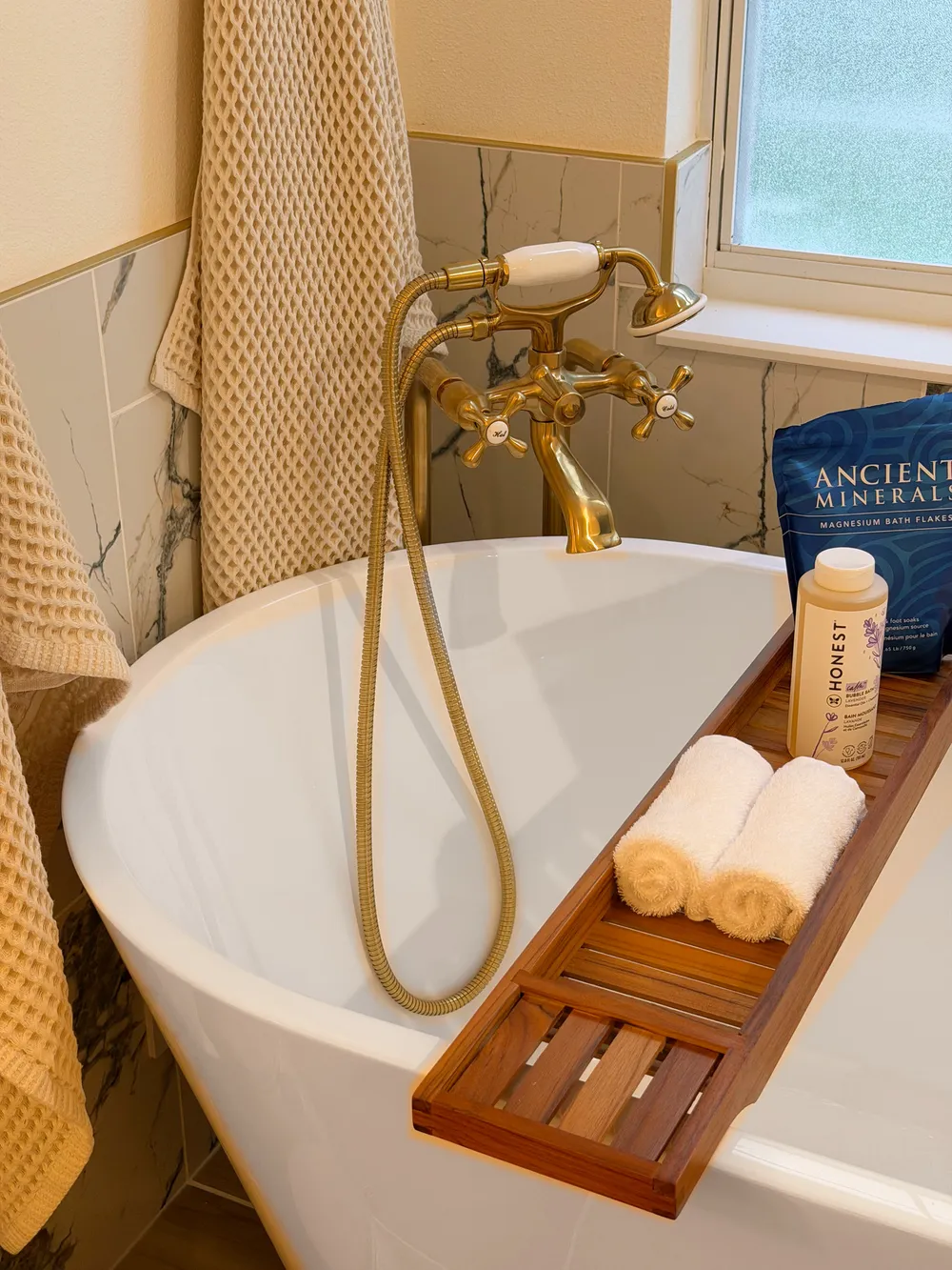 Tub filler and handheld sprayer in the Calle bathroom.