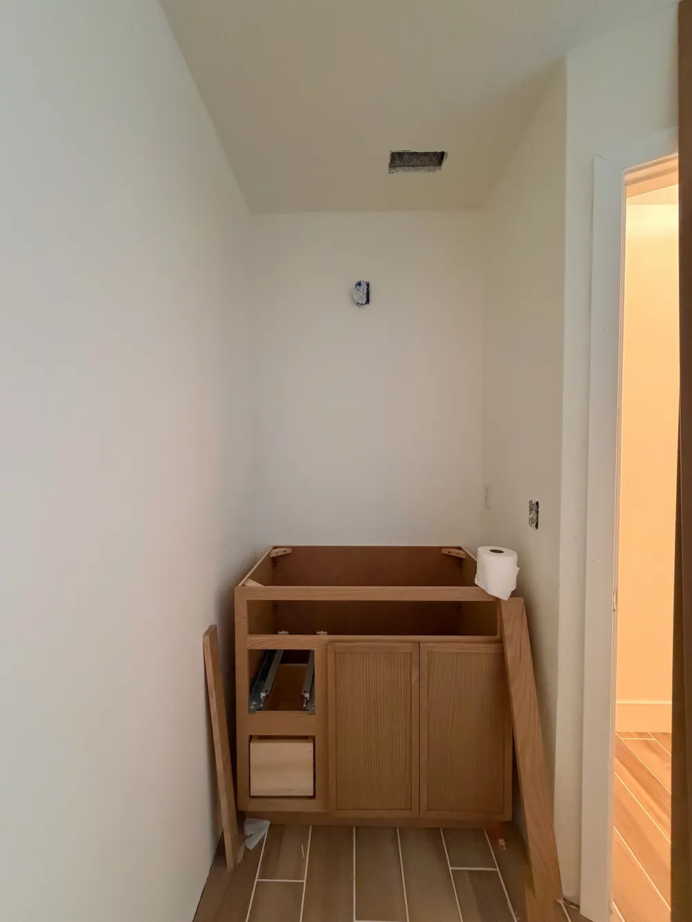 Vanity rough-in and open cabinet in the Calle bathroom.