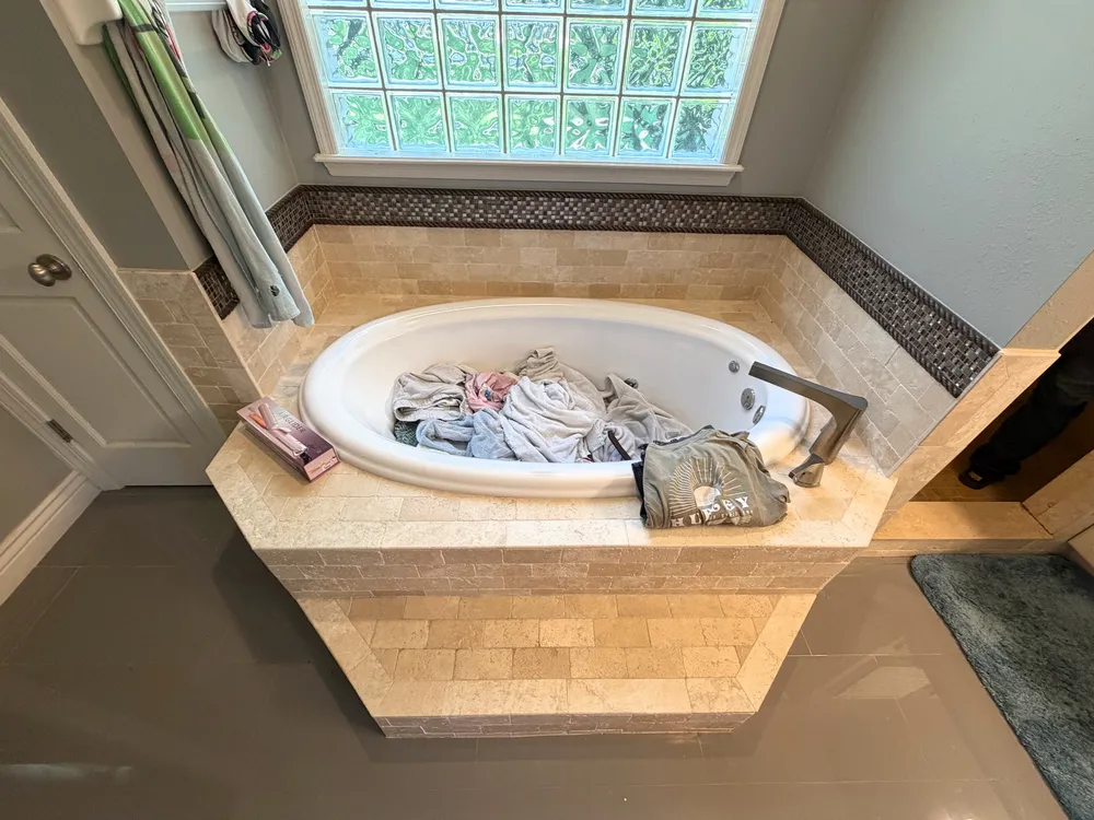 Elevated view of the original tiled tub deck and partition beside the Estancia shower.