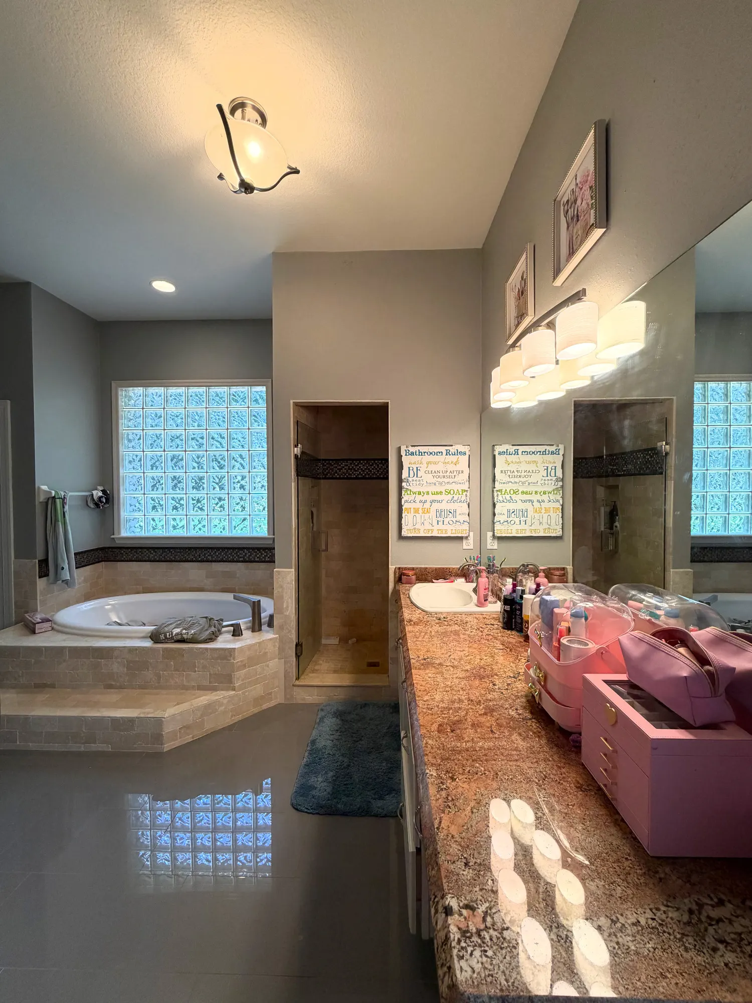 Original Estancia bathroom with an enclosed shower, large tiled tub deck and a long vanity.