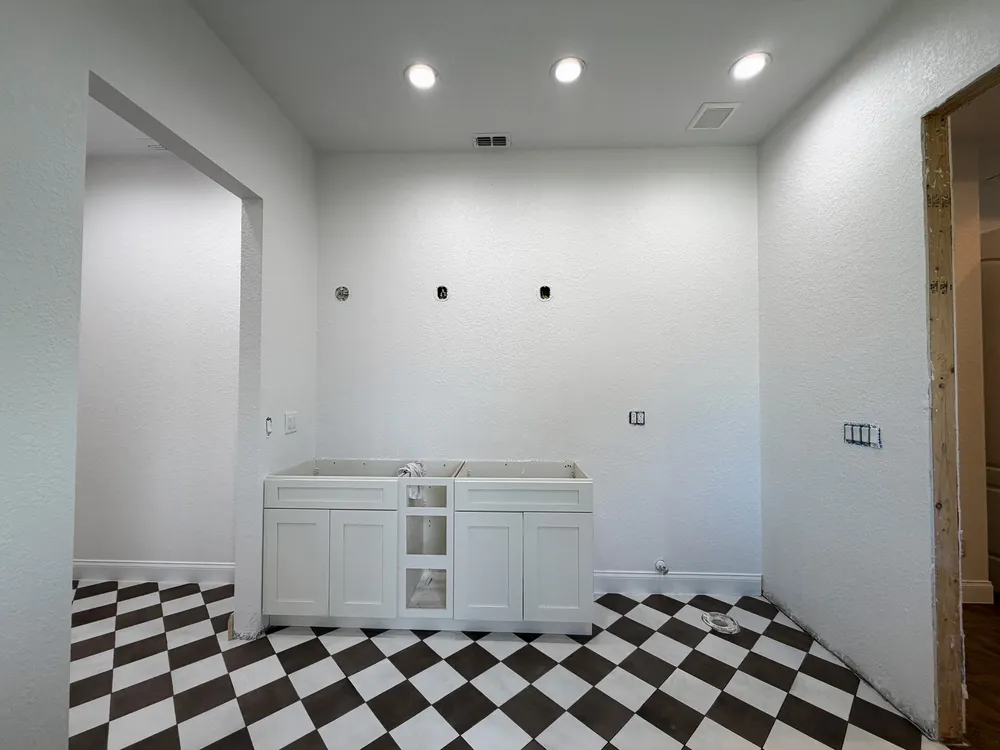 Vanity before counter and mirrors in the Pompano bathroom.