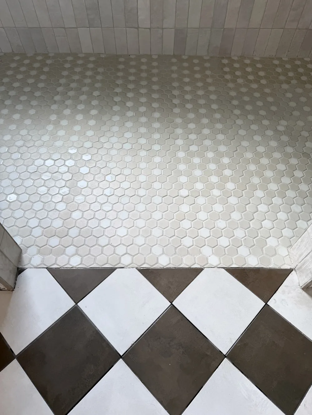 Shower floor transition in the Pompano bathroom.