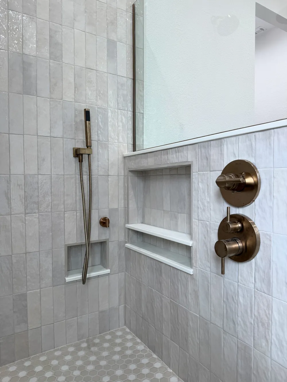 Shower niches and controls in the Pompano bathroom.