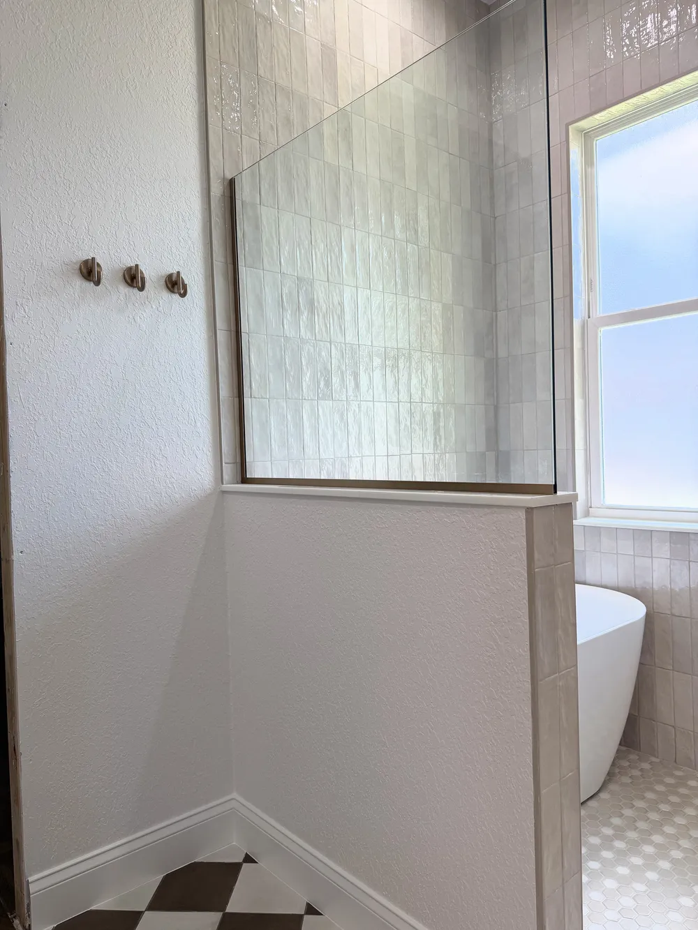Glass partition and tub in the Pompano bathroom.