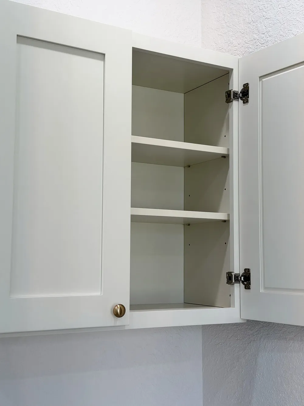 Finished open storage cabinet in the Pompano bathroom.