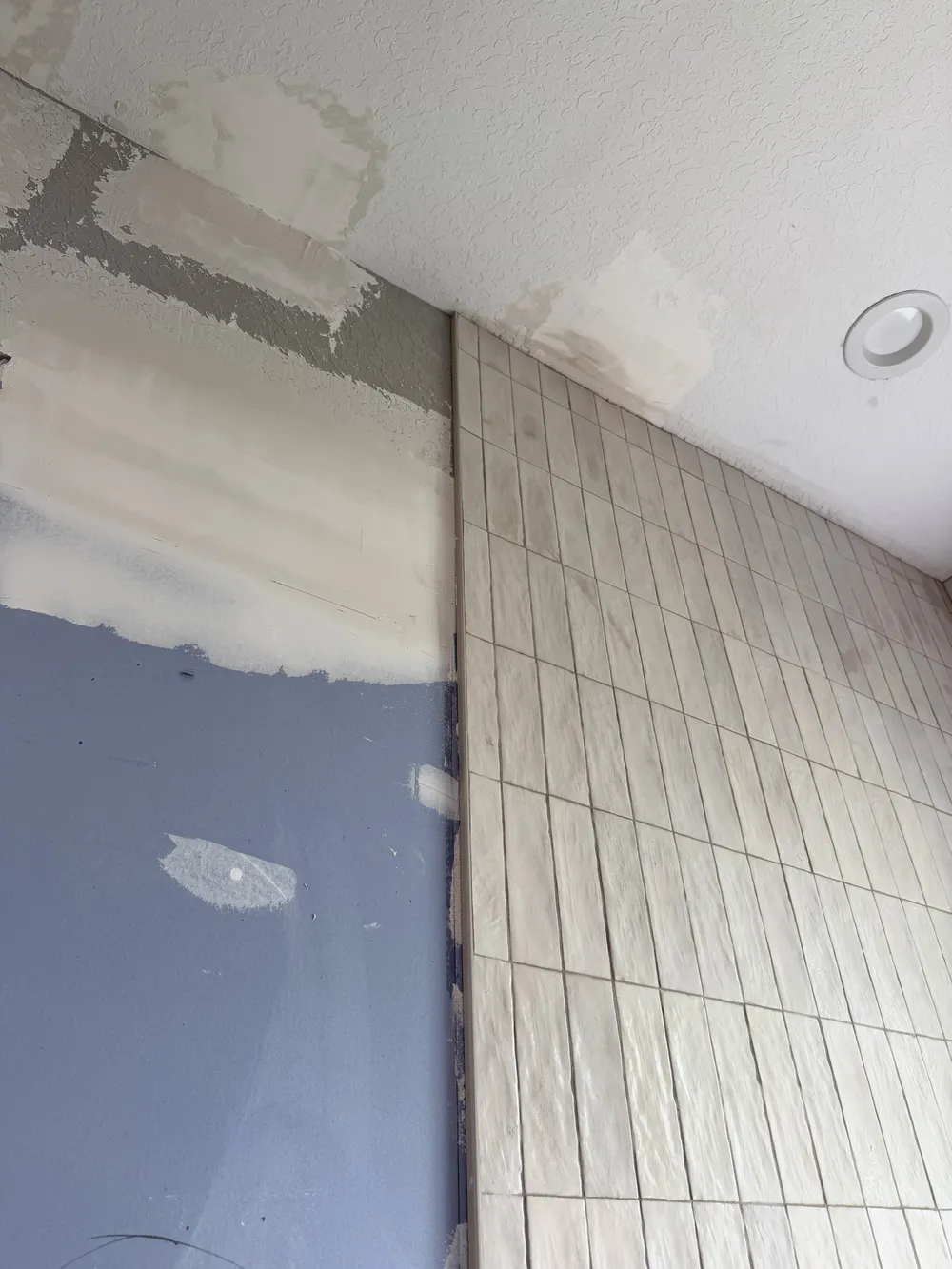 Tile-to-drywall transition in the Pompano bathroom.