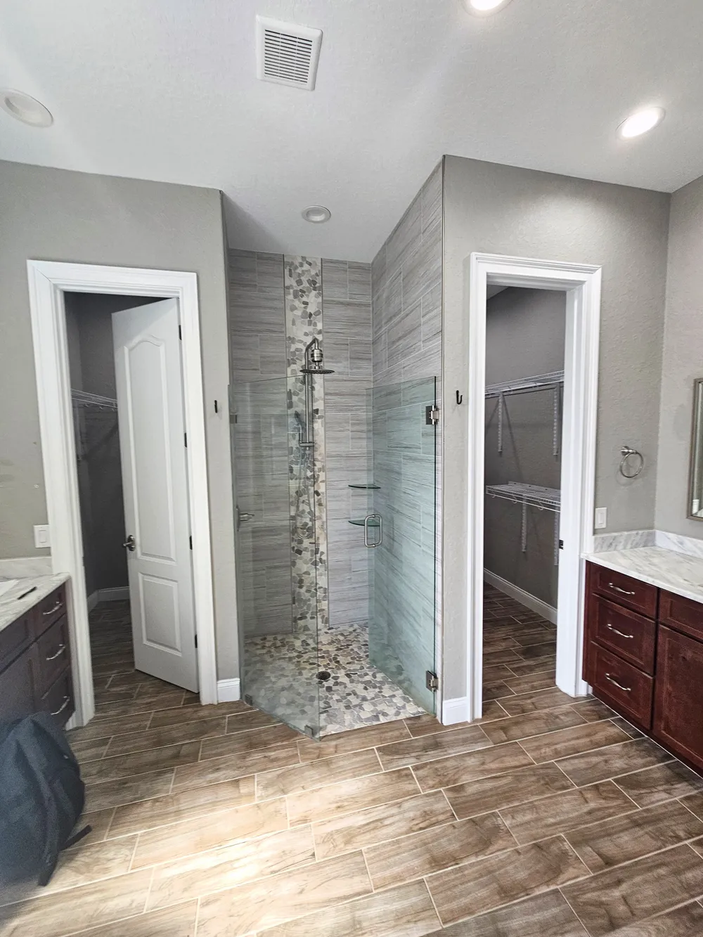 Pompano bathroom before remodeling, showing the enclosed shower between two closet doorways.