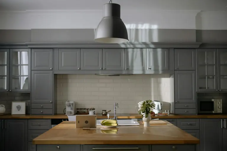 Gray Cabinets with Crown Molding and Butcher Block Countertop