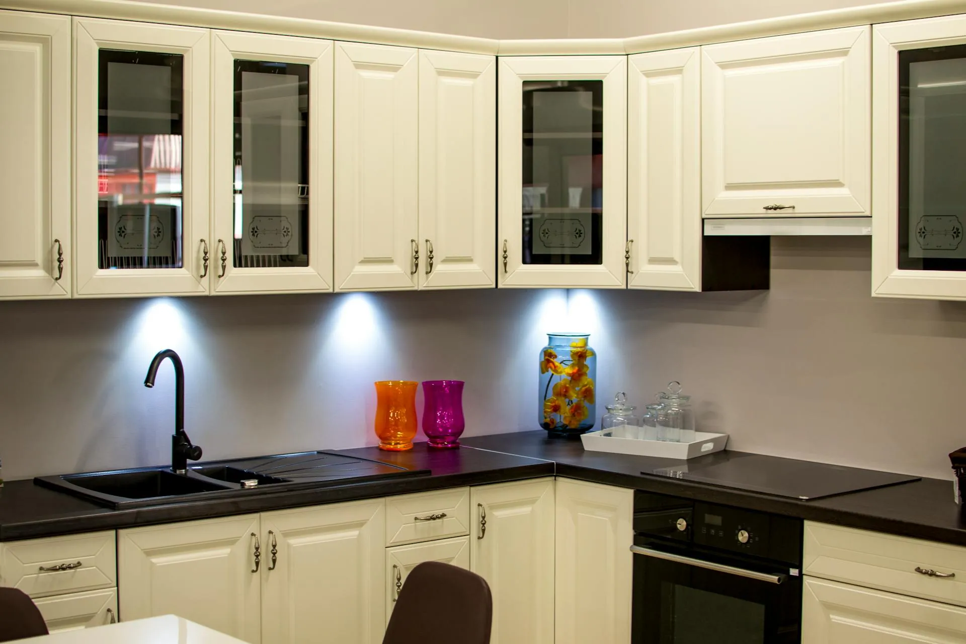 Kitchen with Cream Cabinets and Black Countertop