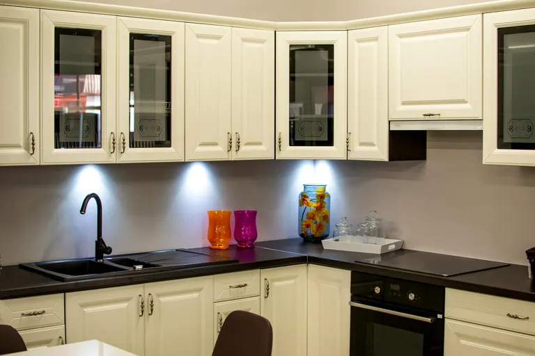 Kitchen with Cream Cabinets and Black Countertop