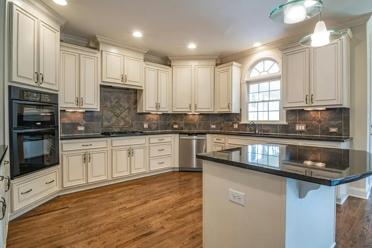 Kitchen with Wood Flooring and Contemporary Cabinets