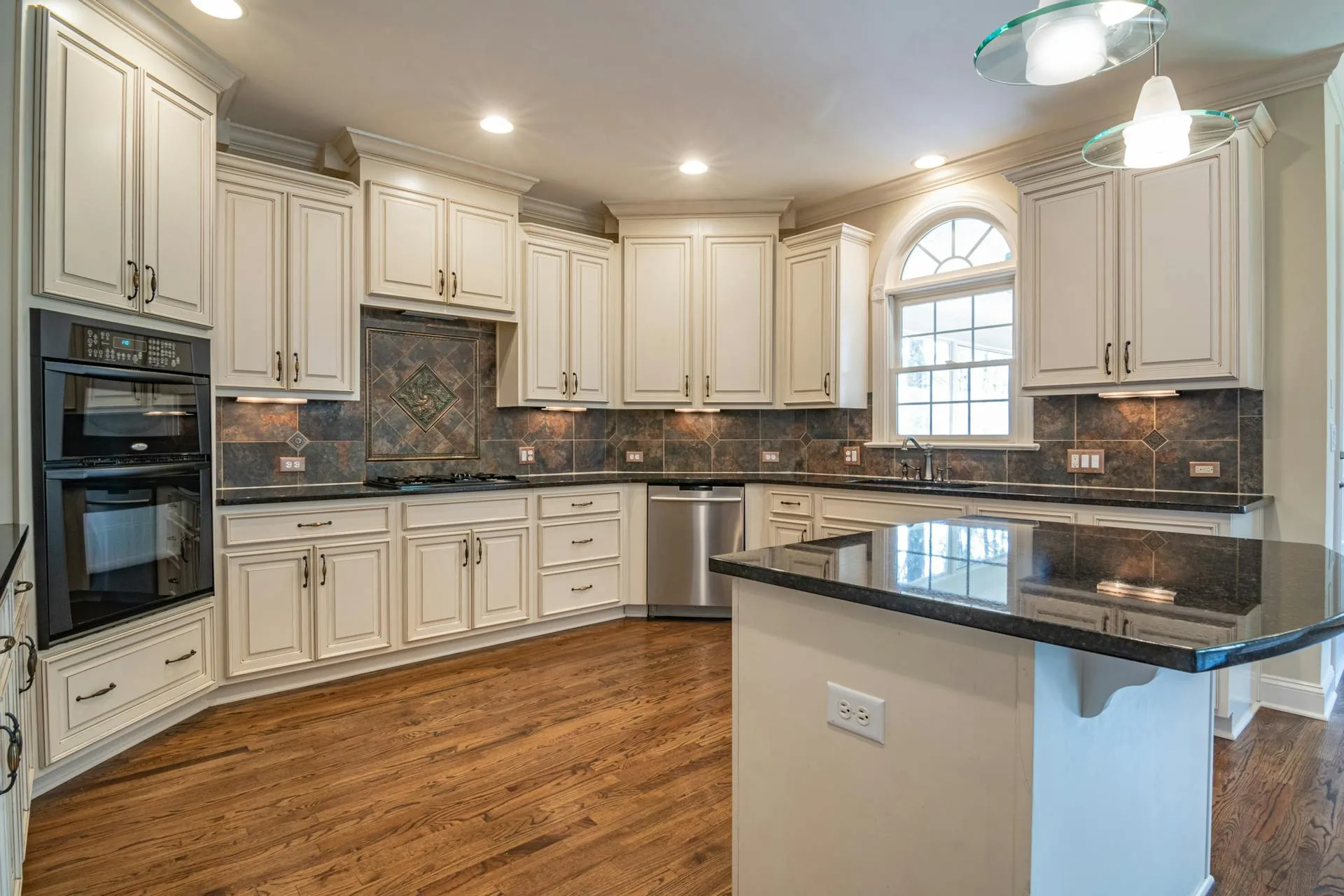Kitchen with Wood Flooring and Contemporary Cabinets