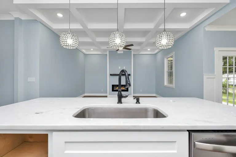 White Grey Modern Solid Surface Countertops Kitchen with Pendant Lights and Blue Walls